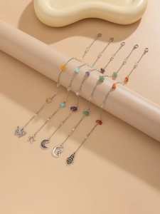 Detail of bohemian chains featuring diverse charms like butterflies and natural stone beads