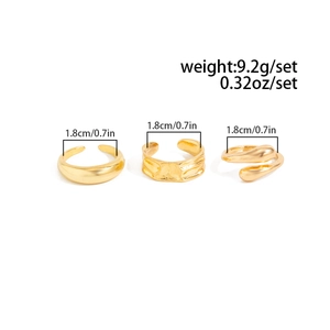 Three-piece gold ring set featuring smooth band, textured wide ring and teardrop style