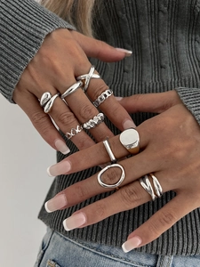 Close-up of 10-piece silver geometric ring set featuring chain and twisted designs