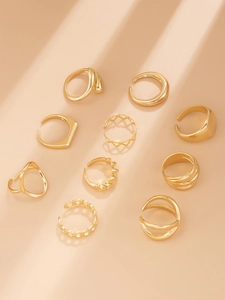 Detailed flat lay of a 10-piece gold ring set featuring geometric and heart designs