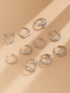 Detailed view of a 10-piece set of silver geometric rings in various textured designs