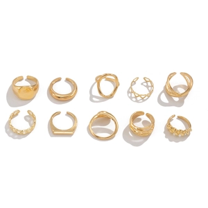 Set of 10 gold geometric rings featuring hollow heart, twisted waves, and chunky metal bands