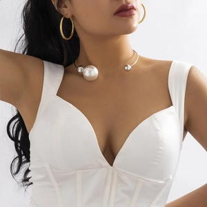Minimalist asymmetric silver choker featuring large faux pearl and metallic beads on model
