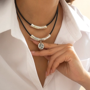 Vintage double layer necklace with embossed bird pendant and silver textured curved tubes