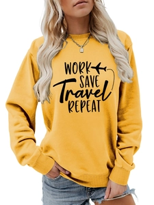 Detail of yellow sweatshirt featuring WORK SAVE Travel REPEAT text and plane graphic