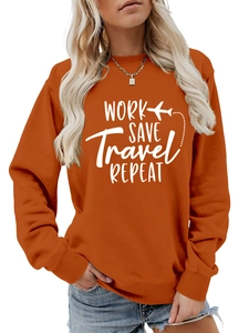 Close-up of rust orange sweatshirt showing white silk-screen print and ribbed cuffs