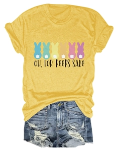 Flat lay of yellow t-shirt with bunny silhouettes and distressed denim shorts set