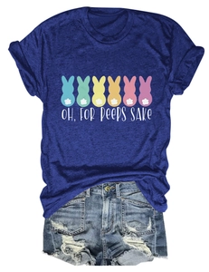 Flat lay of gray-blue Easter t-shirt with bunny silhouettes and distressed denim shorts