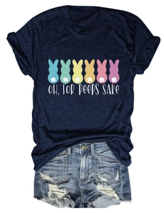 Detail of navy t-shirt with colorful rabbits and denim shorts in a flat lay setup