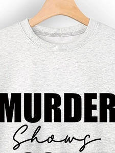 Detail of grey crewneck sweatshirt with black MURDER Shows graphic print and ribbed collar