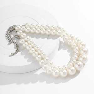 Detail view of double-layer pearl necklace with silver lobster clasp and adjustable chain