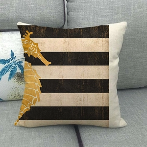 Detailed view of linen cushion cover with golden seahorse print and striped background