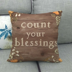 Detail of linen pillow cover with count your blessings text and fall harvest elements