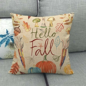 Linen square pillow cover with Hello Fall pumpkin print on a cozy grey sofa