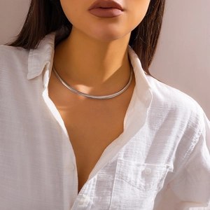 Minimalist silver polished metal choker necklace for women worn with white linen shirt
