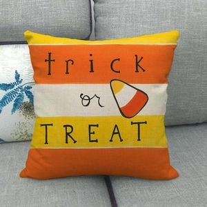 Close-up of Happy Fall linen pillowcase with trick or treat text and candy corn design
