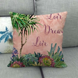 Close-up of linen pillowcase featuring tropical palms and Love Dream Live artistic text