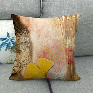 Close-up of linen pillow cover featuring Buddha relief and golden ginkgo leaf pattern