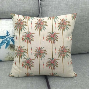 Linen Christmas pillowcase featuring colorful pine trees on a gray sofa background