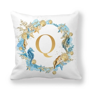 Detailed macro view of the nautical wreath with golden letter Q on peach skin pillowcase