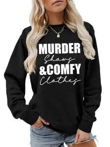 Close-up of black crewneck sweatshirt with white Murder Shows & Comfy Clothes lettering