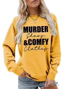 Detail of ginger yellow crewneck sweatshirt with black MURDER SHOWS letter print