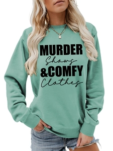 Close-up of light green sweatshirt with Murder Shows and Comfy Clothes text print