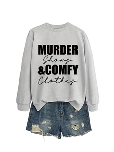 Light grey crewneck sweatshirt with black slogan paired with distressed denim shorts