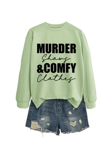 Detail of mint green sweatshirt with Murder Shows text and ripped denim shorts set