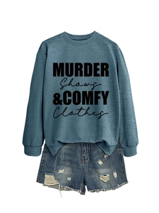 Flat lay of gray sweatshirt with Murder Shows text and distressed denim shorts