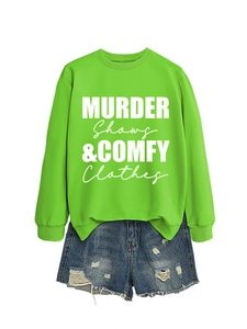 Flat lay of neon green sweatshirt with Murder Shows text and distressed denim shorts