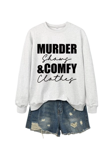Flat lay of light grey sweatshirt with Murder Shows slogan and ripped denim shorts