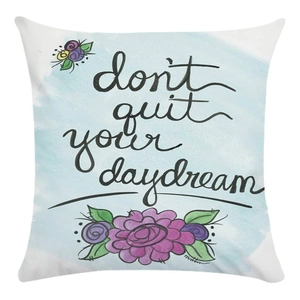 Detail of floral pillowcase with blue watercolor and 'don't quit your daydream' text