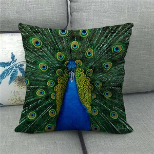 Linen pillow cover with peacock feather oil painting pattern on a grey sofa