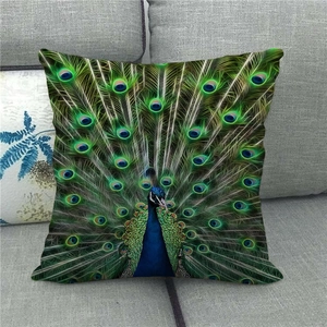 Close-up of linen cushion cover with peacock oil painting on a gray fabric sofa