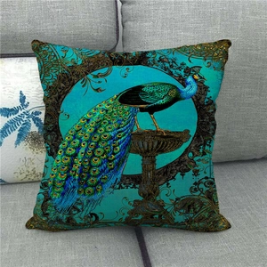 Close-up of peacock pattern cushion cover on gray sofa with detailed linen texture