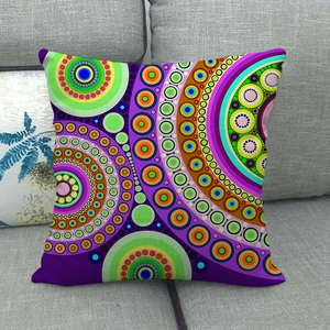 Bohemian linen pillowcase with colorful mandala patterns on a grey sofa