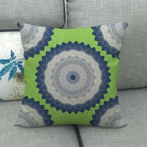 Detailed texture of bohemian geometric mandala linen pillowcase on a grey sofa