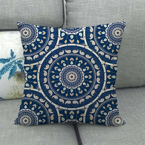 Detail of bohemian mandala geometric pattern on navy linen pillowcase over sofa