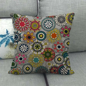 Detail of bohemian mandala patterned linen pillow cover on a modern home sofa