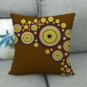 Detailed close-up of colorful dot pattern on brown linen geometric throw pillow