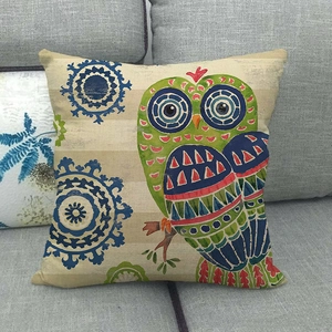 Detail of colorful owl and blue mandala pattern on linen decorative throw pillow case