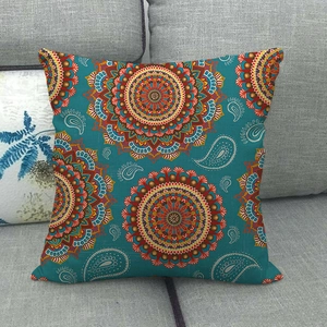 Detailed close-up of teal linen cushion cover with intricate orange mandala patterns
