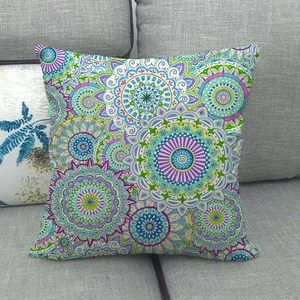 Close-up of geometric mandala pattern on textured linen pillowcase on a grey sofa