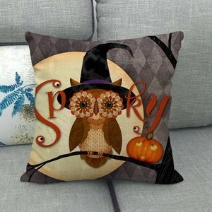 Halloween owl and pumpkin linen pillow cover displayed on a grey sofa setting