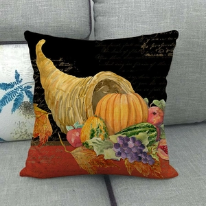 Detail of linen pillowcase with autumn pumpkin and fruit print on a grey sofa