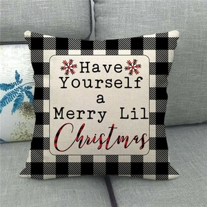 Detail of Christmas pillow cover with black and white buffalo plaid and merry text