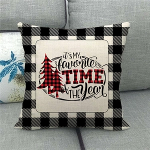 Merry Christmas linen pillow cover with red buffalo plaid pine tree on a grey sofa