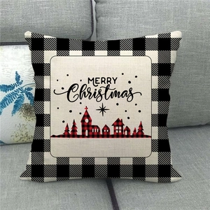 Close-up of Merry Christmas linen pillowcase with red plaid church and pine tree pattern