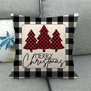 Detail of Christmas buffalo plaid pillow cover with red pine trees and Merry Christmas text